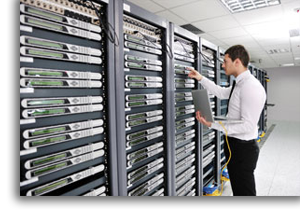 Man with computer in hand and conducting tests on memory bank room.