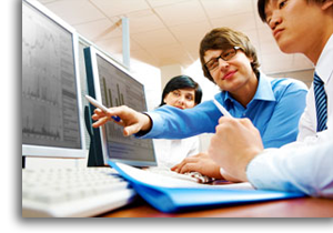 Coworker poiting to computer screen to show information.