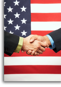 Two people shaking hands with the US flag in the background.