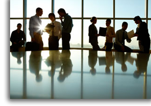 A group of business people in shadow.